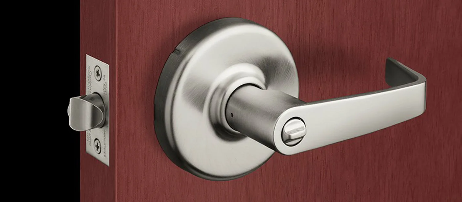 Satin-nickel commercial lever handle installed on a hardwood office door